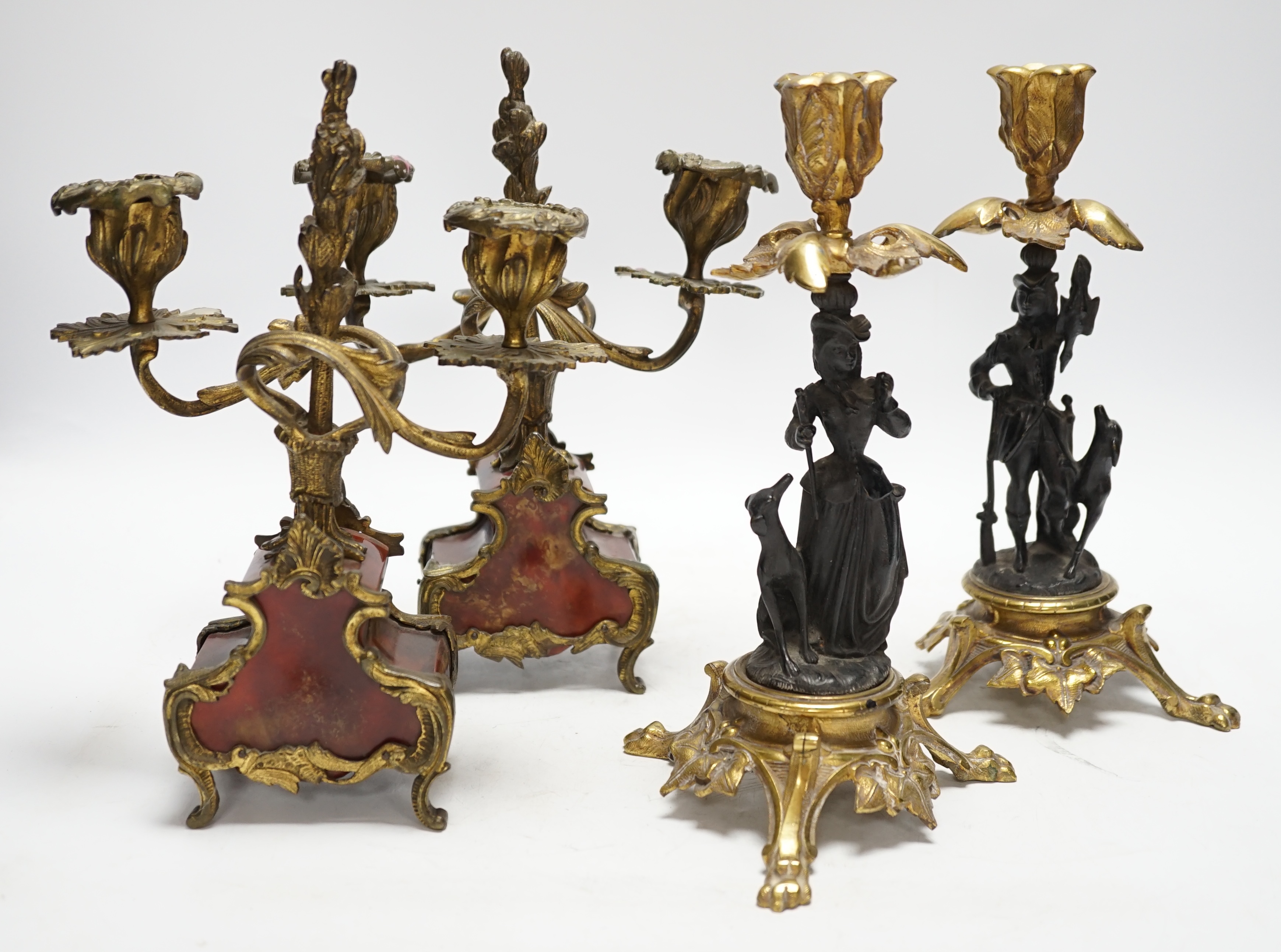 A pair of Victorian bronze and gilt metal figural candlesticks and a pair of tortoiseshell and gilt metal candelabra, largest 24cm high